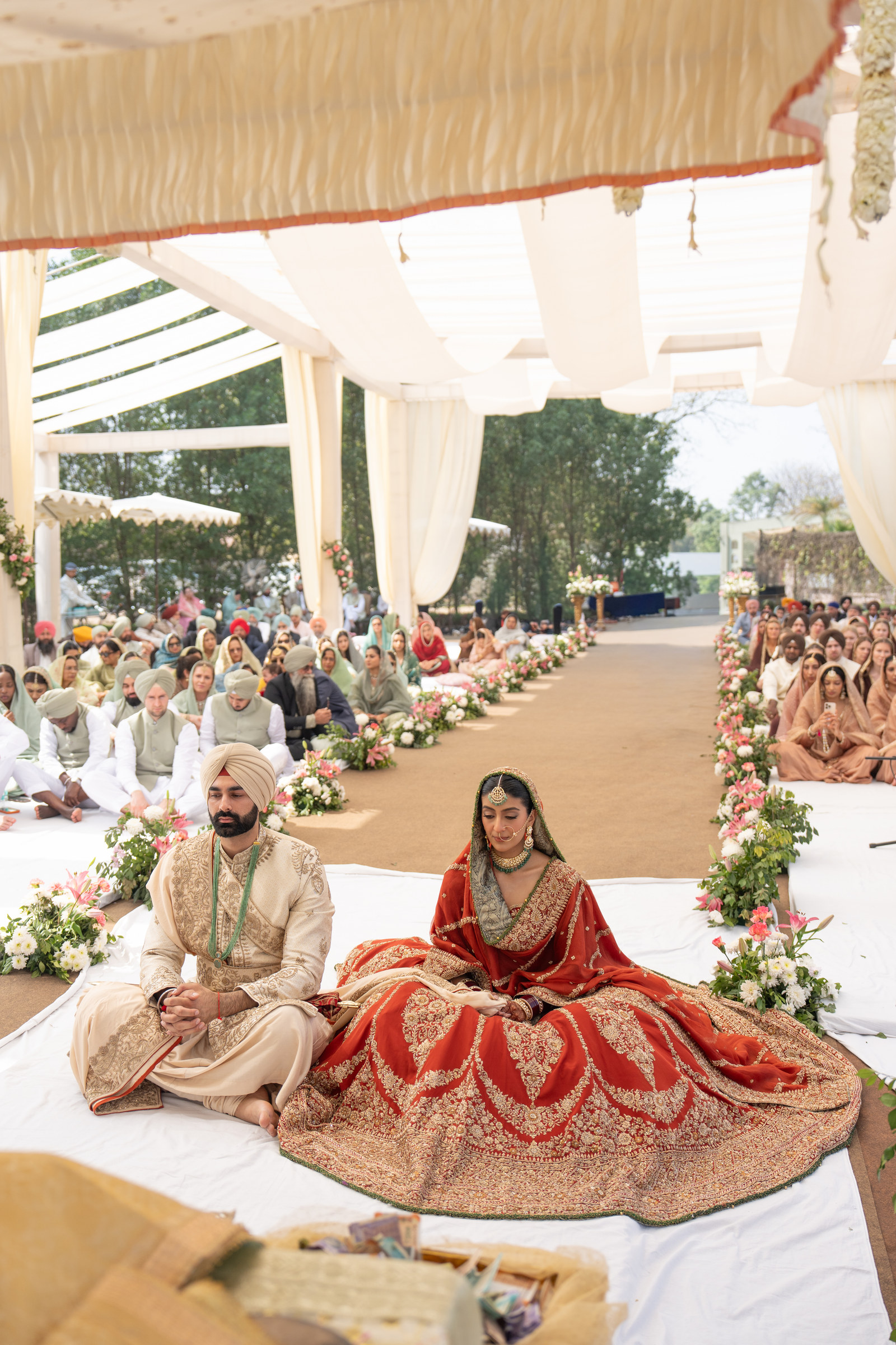 The couple seated during their Anand Karaj ceremony